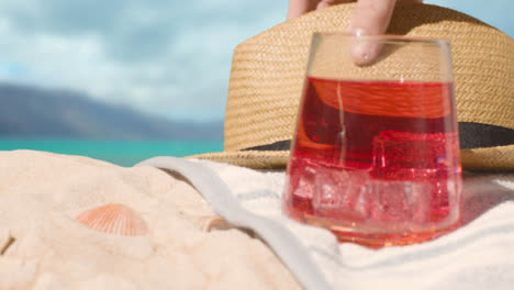 Summer-Holiday-Concept-Of-Cold-Drink-On-Beach-Towel-With-Sun-Hat-Against-Sea-Background-2