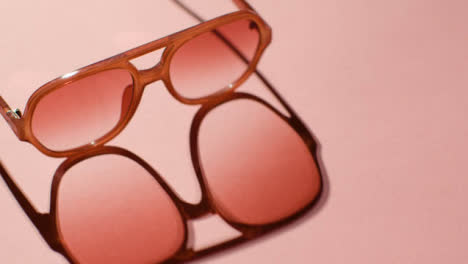 Summer-Holiday-Concept-Of-Sunglasses-On-Pink-Background-1