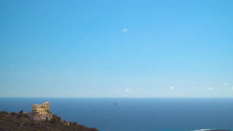 View-From-Cliffs-With-Building-Of-Coastline-And-Clear-Blue-Sea