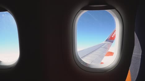 View-From-Plane-Window-Of-Blue-Sky-And-Clouds-On-Flight-To-Summer-Holiday-Vacation-3
