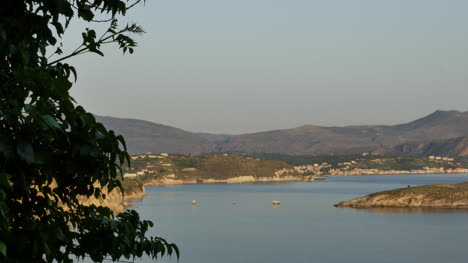 Greece-Crete-A-Vine-Frames-View-Of-A-Bay