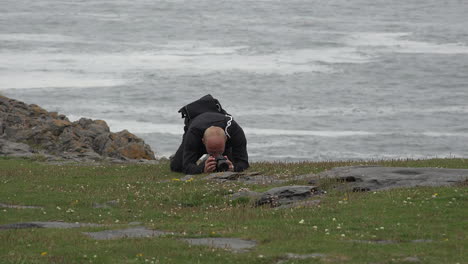 Ireland-The-Burren-Man-Photographing-A-Flower-On-The-Ground-