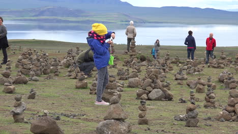 Iceland-Landscape-With-Cairns-And-Woman-Taking-Photos-Pan