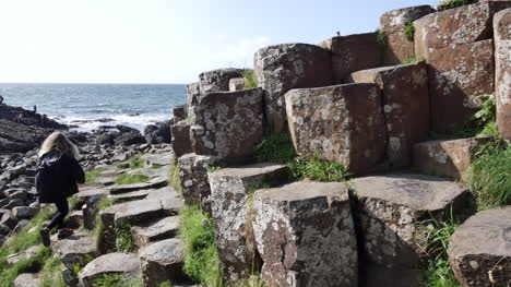 Northern-Ireland-Giants-Causeway-Tourists-Walk-Past-Hexagonal-Stones