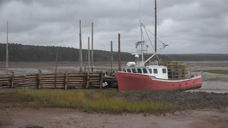 Canada-Nova-Scotia-Red-Boat-By-Log-Dock-Under-Clouds