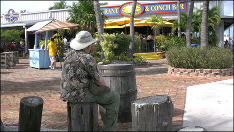 Florida-Key-West-Harbor-Area-Man-Sitting-On-Log