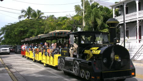 Florida-Key-West-Street-With-Tourists-On-Open-Trolley-Editorial