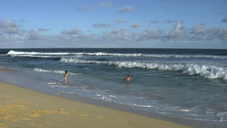 Oahu-Sandy-Beach-Playing-In-Surf