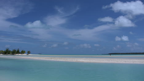 Aitutaki-Couple-On-Sand-In-Lagoon