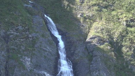 Alaska-Waterfall-On-Dark-Rock-Tilt-Down