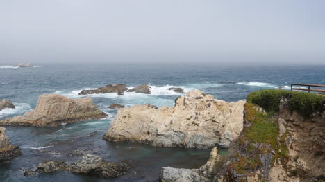 California-Big-Sur-Rock-At-Soberanes-Point-Person-In-Distance
