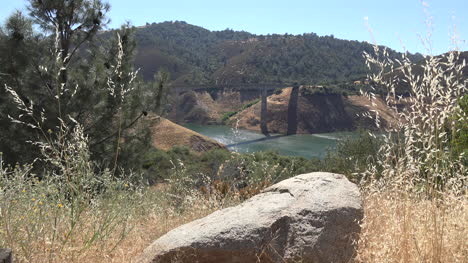 California-Rock-By-Lake-With-Bridge