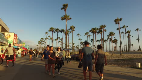 Los-Angeles-Venice-Beach-Walking-Down-Boardwalk-Past-Visitors
