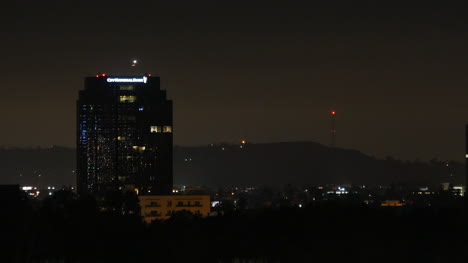 Los-Angeles-A-Building-At-Night-With-An-Airplane