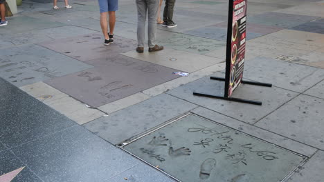 Los-Angeles-Tourists-Walk-By-Names-In-Concrete-On-The-Hollywood-Walk-Of-Fame