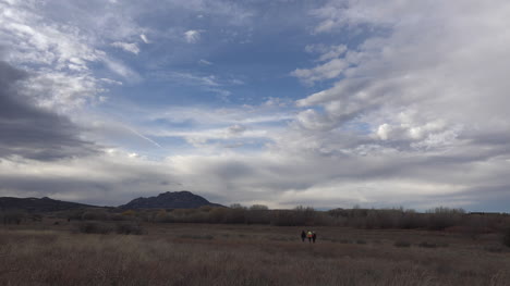 Arizona-People-Walking-Under-Dramatic-Sky