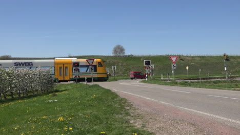 Germany-Train-Passes-Crossing-And-Orchards-With-Sound