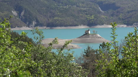 France-Chapel-On-Island-Sits-In-Lac-Serre-Poncon-Zoom-Out