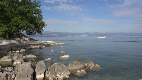 Croatia-Lovran-Boat-Goes-By-Rocks