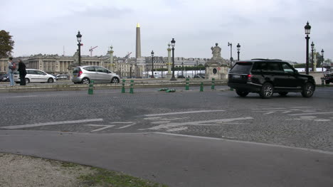 Paris-man-taking-picture-and-traffic-by-obelisk