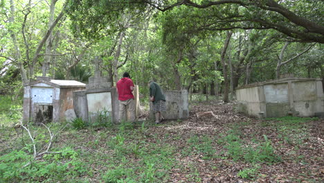 Louisiana-woman-and-boy-look-at-old-tombs
