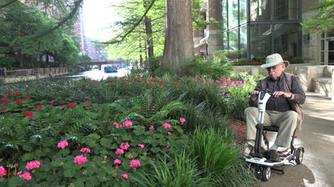 San-Antonio-man-on-scooter-by-flowers-on-River-Walk