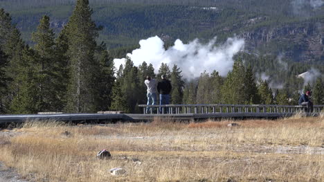 Yellowstone-men-on-boardwalk-with-geyser-steam