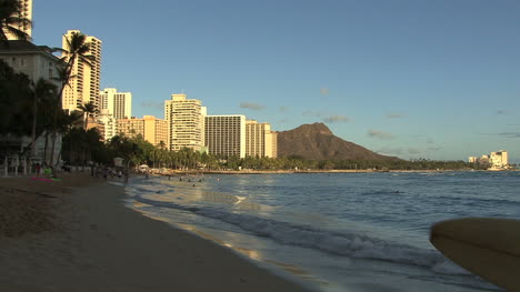 Waikiki-man-with-surfboard-on-beach