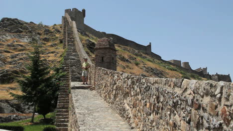 Portugal-Marvao-city-walls-climb-hill-behind-tourist