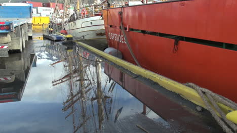 Argentina-Ushuaia-reflected-masts-and-red-hull