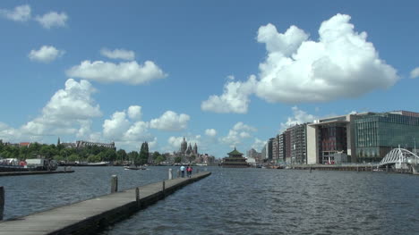 Netherlands-Amsterdam-people-walk-toward-end-of-pier