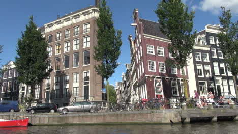 Netherlands-Amsterdam-upward-at-building-rounding-bend-in-canal