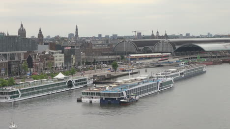 Amsterdam-sailing-out-past-barges