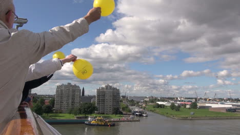 Netherlands-Rotterdam-cruise-waving-yellow-balloons-at-yellow-tug