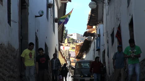 Cusco-street-with-people-and-flags-s