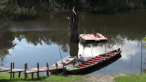 Brazilian-Amazon-man-sitting-on-a-canoe-in-a-jungle-stream