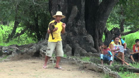 Brazil-Boca-da-Valeria-tree-and-people-including-man-with-monkey