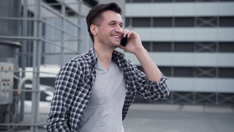 Handsome-Young-Man-Talking-On-The-Phone-And-Laughing-On-The-Street