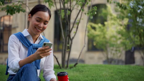 Woman-Watching-Her-Smartphone-Outdoors