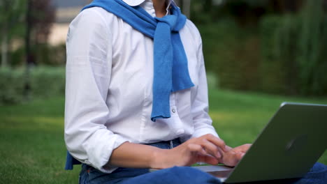 Cheerful-Woman-Using-Her-Laptop-Outdoors-1