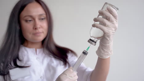 Close-Up-Of-A-Female-Doctor-Filling-A-Syringe-With-A-Vaccine