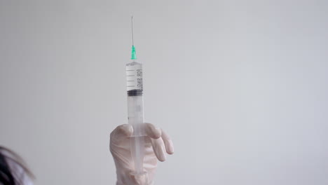 Close-Up-Of-Doctor-Hand-Holding-A-Syringe-With-A-Vaccine