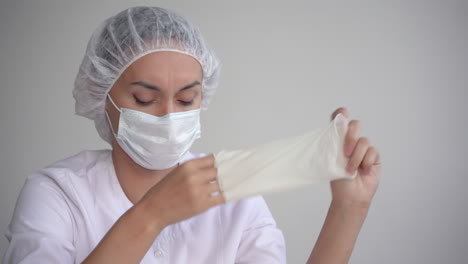 Tired-Female-Doctor-Taking-Off-Medical-Gloves-And-Face-Mask