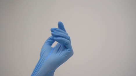 Close-Up-Of-Hands-Of-Doctor-Putting-On-Medical-Gloves