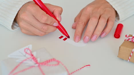 Female-Hands-Decorate-And-Color-A-Candy-Cane-Made-Of-Paper-Using-A-Marker-Pen