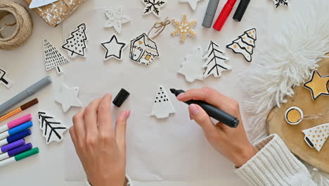 Woman-Hand-Paints-Ornaments-With-Christmas-Tree-Shape
