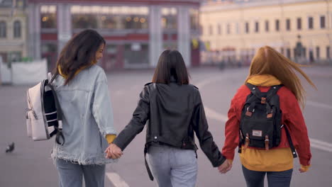 Multi-Ethnic-Women-Walk-Together-Hand-In-Hand-Outdoors