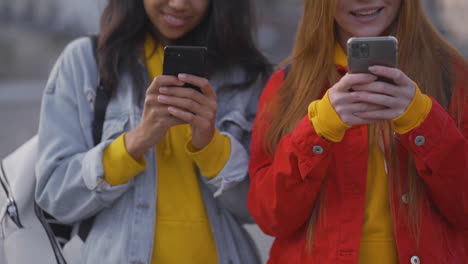 Multi-Ethnic-Happy-Female-Friends-Using-Smartphones