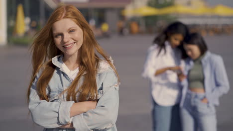 Young-Red-Haired-Woman-Poses-Smiling-At-Camera