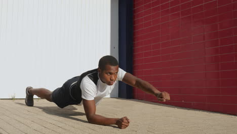 Young-Black-Man-Stretching-Before-Running-Outdoors